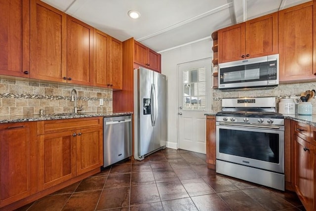 2660 Rosebud Ave, Merrick, NY 11566 - kitchen featuring appliances with stainless steel finishes, backsplash, light stone counters, brown cabinets, and recessed lighting