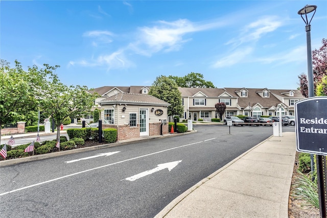 1011 Willow Ln, Valley Stream, NY 11580 - view of asphalt street featuring curbs, street lights, a residential view, sidewalks, and traffic signs