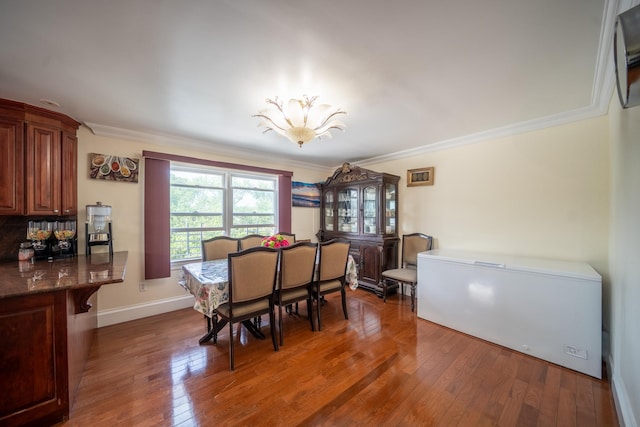 580 Valley Ave, Yonkers, NY 10703 - dining area with ornamental molding, wood finished floors, and a chandelier