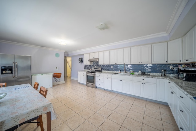 580 Valley Ave, Yonkers, NY 10703 - kitchen featuring stainless steel appliances, crown molding, light tile patterned floors, backsplash, and under cabinet range hood