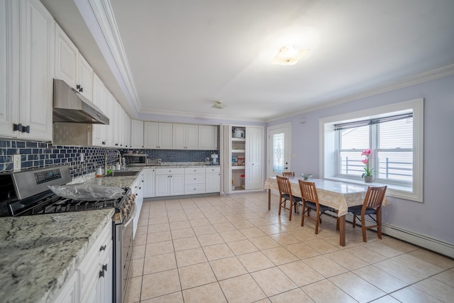 580 Valley Ave, Yonkers, NY 10703 - kitchen with stainless steel appliances, under cabinet range hood, ornamental molding, light tile patterned floors, and backsplash