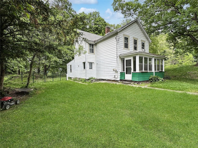 9 Church St, Hyde Park, NY 12538 - view of side of property with a sunroom, a chimney, and a lawn