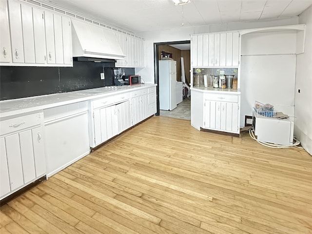 9 Church St, Hyde Park, NY 12538 - kitchen featuring premium range hood, freestanding refrigerator, light wood-type flooring, and light countertops