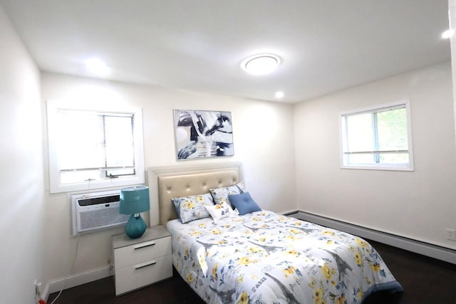 18 Park Dr E, Syosset, NY 11791 - bedroom with baseboard heating, an AC wall unit, baseboards, recessed lighting, and dark wood-style floors