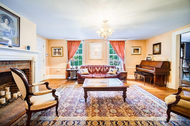 9 Ireland Ave, Wappingers Falls, NY 12590 - living room featuring wood finished floors, a fireplace, a chandelier, and baseboards