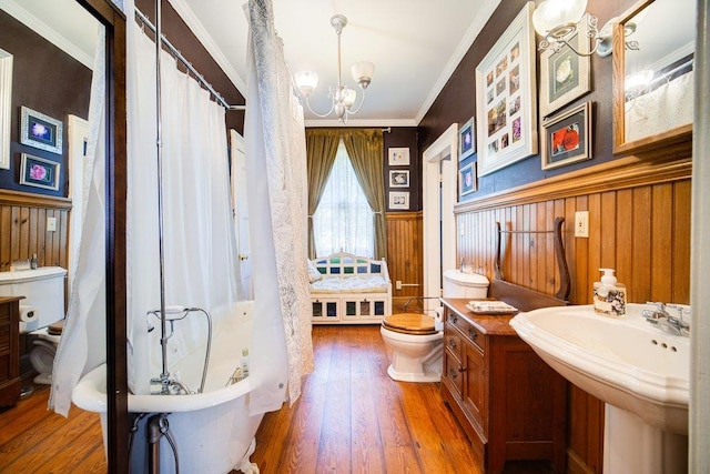 9 Ireland Ave, Wappingers Falls, NY 12590 - full bath featuring toilet, a chandelier, hardwood / wood-style flooring, ornamental molding, and wainscoting