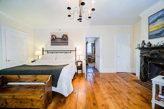 9 Ireland Ave, Wappingers Falls, NY 12590 - bedroom with a chandelier, a fireplace, hardwood / wood-style floors, ornamental molding, and baseboards