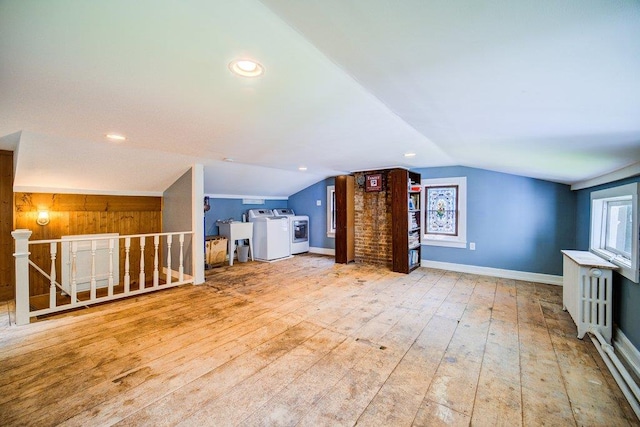 9 Ireland Ave, Wappingers Falls, NY 12590 - unfurnished living room with lofted ceiling, hardwood / wood-style floors, baseboards, and separate washer and dryer