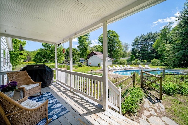 9 Ireland Ave, Wappingers Falls, NY 12590 - deck featuring an outdoor pool, view of wooded area, and grilling area