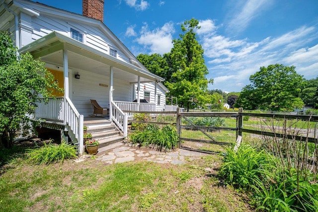 9 Ireland Ave, Wappingers Falls, NY 12590 - view of property exterior featuring a chimney and a porch