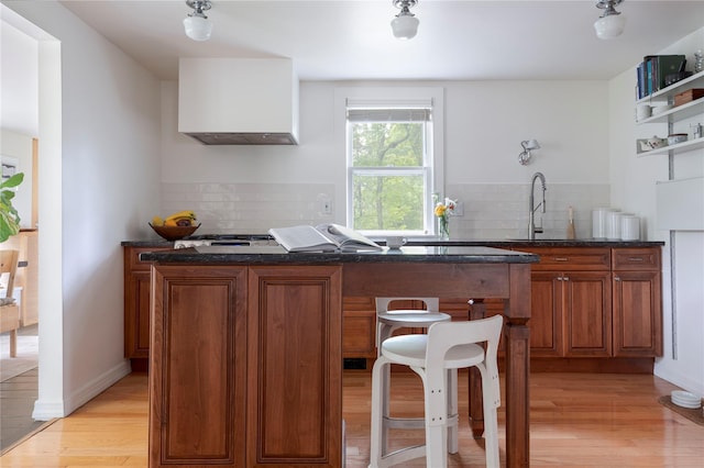24 Jolliffe Ln, Congers, NY 10920 - kitchen featuring a sink, light wood-type flooring, brown cabinets, and tasteful backsplash