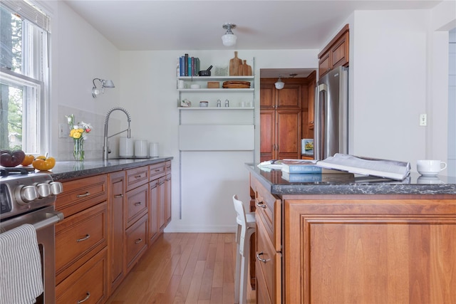 24 Jolliffe Ln, Congers, NY 10920 - kitchen featuring brown cabinets, appliances with stainless steel finishes, a sink, and dark stone countertops