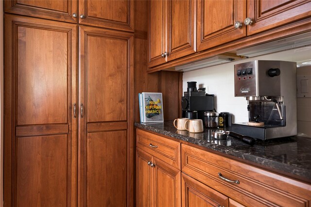 24 Jolliffe Ln, Congers, NY 10920 - kitchen featuring brown cabinetry and dark stone counters