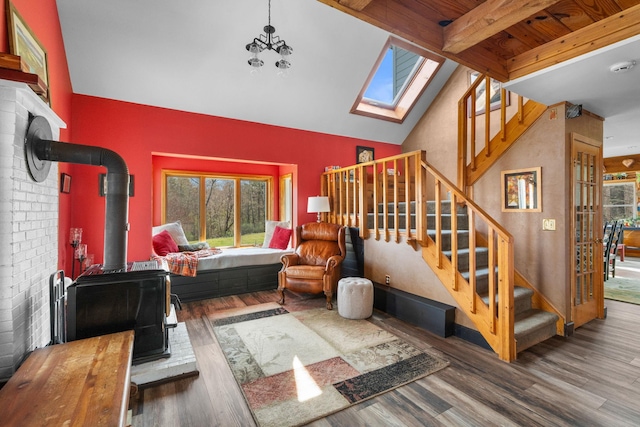 285 County Road 20, Cairo, NY 12413 - living area featuring stairway, wood finished floors, beam ceiling, a wood stove, and high vaulted ceiling