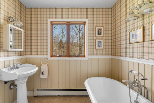 285 County Road 20, Cairo, NY 12413 - bathroom featuring wallpapered walls, a freestanding bath, tile patterned flooring, wainscoting, and baseboard heating