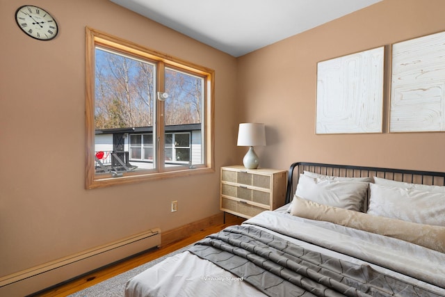 285 County Road 20, Cairo, NY 12413 - bedroom featuring a baseboard heating unit, multiple windows, wood finished floors, and baseboards