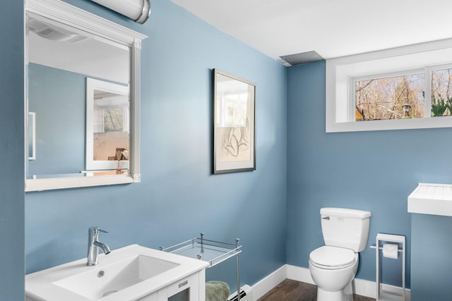 285 County Road 20, Cairo, NY 12413 - half bath featuring a sink, a baseboard heating unit, toilet, baseboards, and wood finished floors