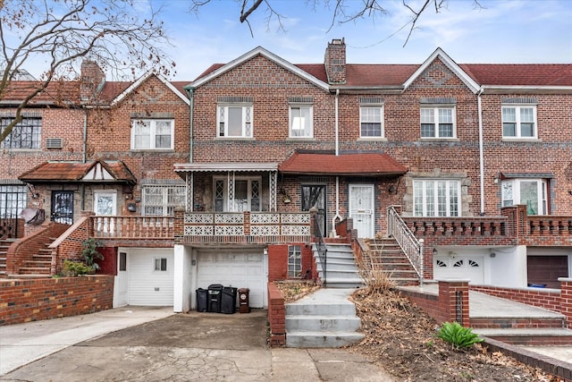 712 E 40th St, Brooklyn, NY 11210 - multi unit property with a garage, concrete driveway, brick siding, and a chimney