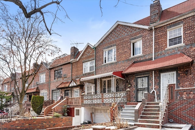 712 E 40th St, Brooklyn, NY 11210 - townhome / multi-family property with brick siding, a chimney, and an attached garage
