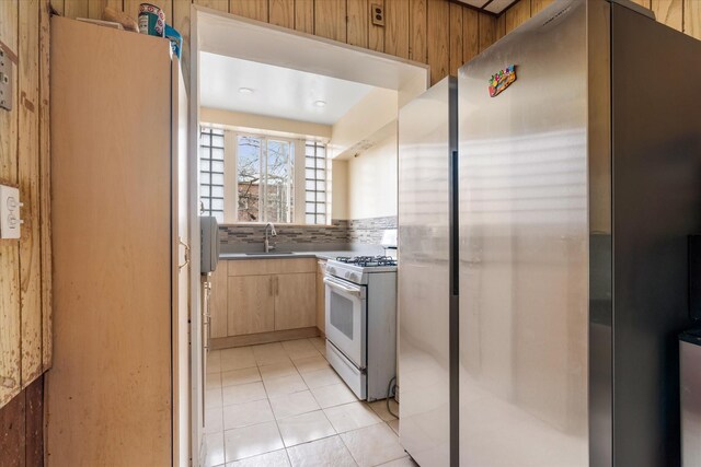 712 E 40th St, Brooklyn, NY 11210 - kitchen with white appliances, a sink, light brown cabinets, and light tile patterned floors