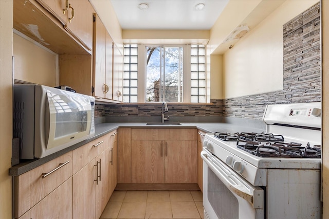 712 E 40th St, Brooklyn, NY 11210 - kitchen with white appliances, a sink, light brown cabinetry, backsplash, and light tile patterned flooring