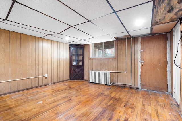 712 E 40th St, Brooklyn, NY 11210 - entrance foyer with radiator heating unit, hardwood / wood-style flooring, a paneled ceiling, and wood walls