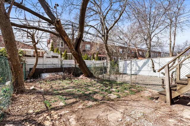 712 E 40th St, Brooklyn, NY 11210 - view of yard with fence and a residential view
