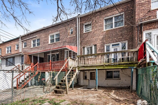 712 E 40th St, Brooklyn, NY 11210 - rear view of property with stairs, brick siding, and a deck