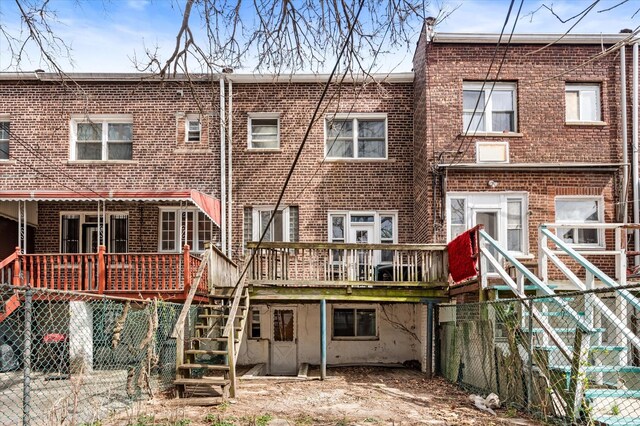 712 E 40th St, Brooklyn, NY 11210 - rear view of property featuring brick siding, stairs, a deck, and fence