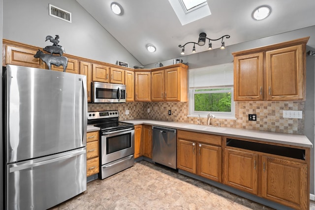 22 Rosio Ln, Modena, NY 12548 - kitchen featuring appliances with stainless steel finishes, a skylight, a sink, light countertops, and vaulted ceiling