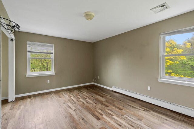22 Rosio Ln, Modena, NY 12548 - empty room with baseboard heating, wood finished floors, healthy amount of natural light, and baseboards