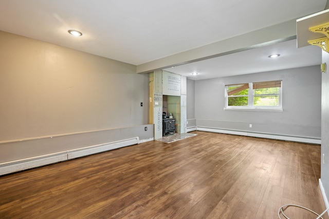 22 Rosio Ln, Modena, NY 12548 - empty room featuring a wood stove, a baseboard radiator, wood finished floors, and recessed lighting