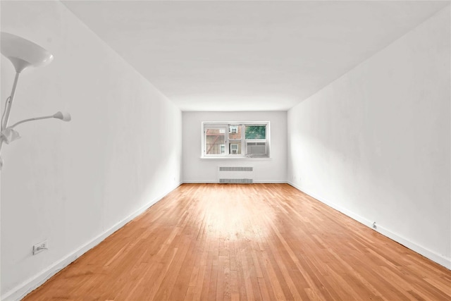 44-69 Kissena Blvd Unit 4, Flushing, NY 11355 - unfurnished room with radiator heating unit, light wood-style floors, and baseboards