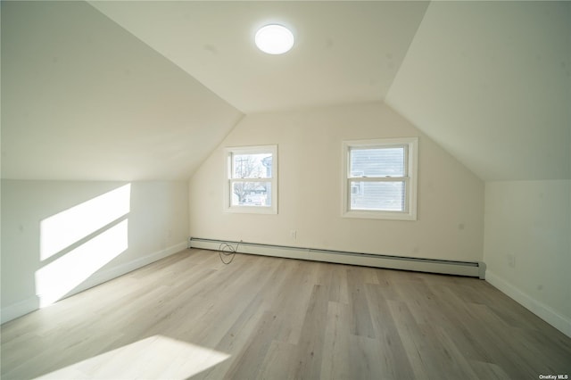 47 Kingfisher Rd, Levittown, NY 11756 - additional living space featuring a baseboard heating unit, light wood-style flooring, baseboards, and vaulted ceiling