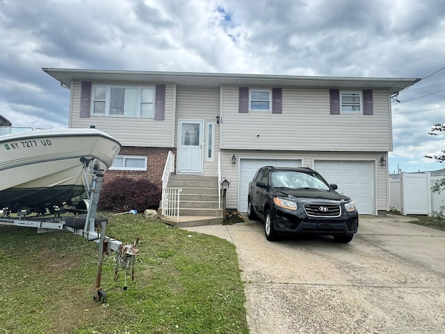 15 W Minerva Rd, Lindenhurst, NY 11757 - bi-level home featuring driveway, a garage, and entry steps