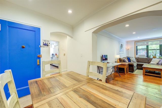 2 Town House Pl Unit 2H, Great Neck, NY 11021 - dining space with arched walkways, wood-type flooring, crown molding, and recessed lighting