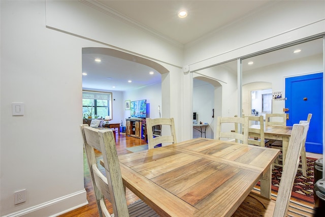 2 Town House Pl Unit 2H, Great Neck, NY 11021 - dining area with arched walkways, wood finished floors, recessed lighting, and crown molding