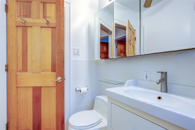 2 Town House Pl Unit 2H, Great Neck, NY 11021 - half bathroom featuring tile walls, toilet, backsplash, and vanity