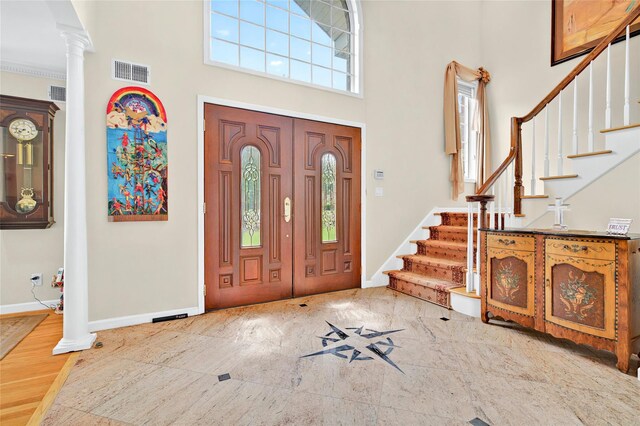 249 Park Ave, Eastchester, NY 10709 - entryway featuring decorative columns, baseboards, a high ceiling, and stairway