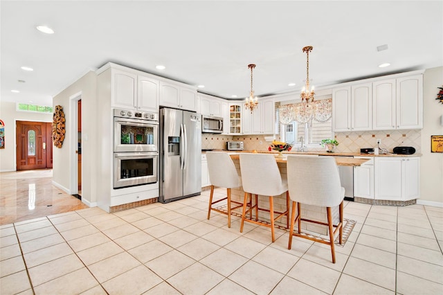 249 Park Ave, Eastchester, NY 10709 - kitchen with appliances with stainless steel finishes, recessed lighting, backsplash, glass insert cabinets, and white cabinetry