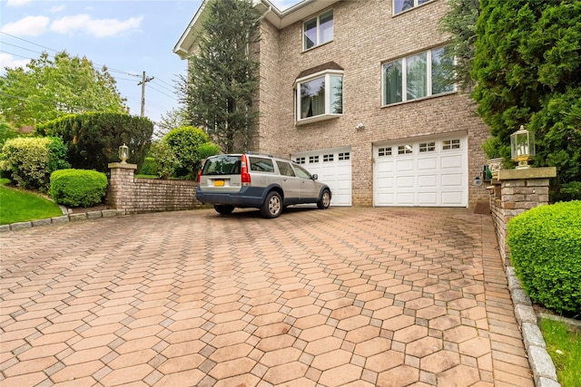 249 Park Ave, Eastchester, NY 10709 - view of front of home with decorative driveway, an attached garage, and brick siding
