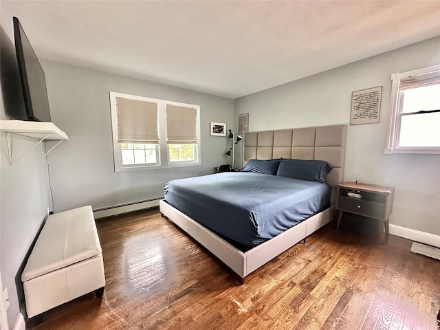 165 Smith Ave, Holbrook, NY 11741 - bedroom featuring baseboard heating, multiple windows, wood finished floors, and baseboards