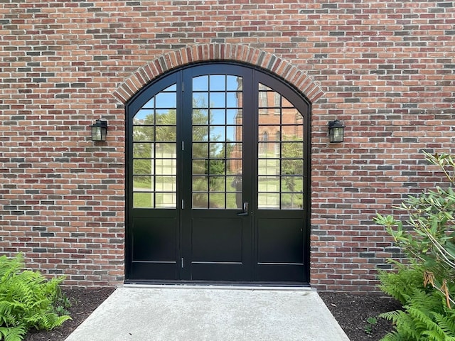property entrance with french doors and brick siding