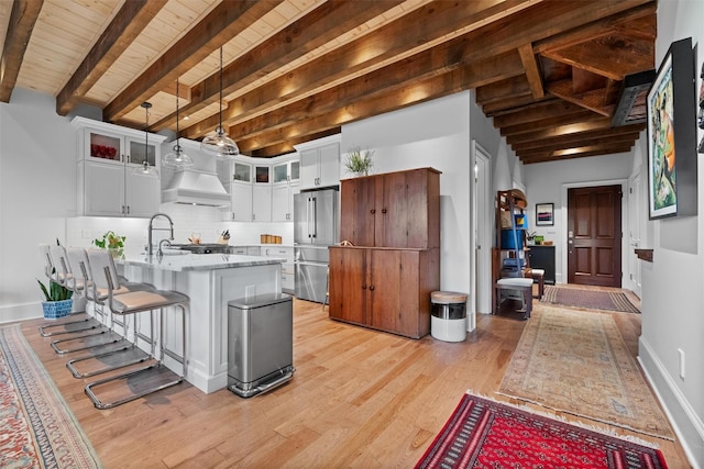 17 River Ridge Court, Beacon, NY 12508 - kitchen featuring high end refrigerator, wood ceiling with exposed beams, light wood-style floors, a kitchen bar, and white cabinetry