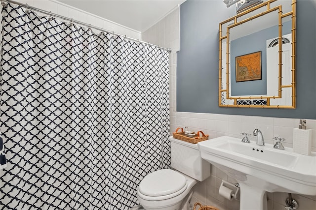 216 Purchase St Unit A, Rye, NY 10580 - bathroom featuring tile walls, toilet, curtained shower, wainscoting, and a sink