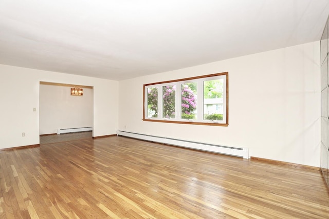 19 Verona Ct, New City, NY 10956 - unfurnished room with a baseboard radiator, light wood-type flooring, a chandelier, and baseboards