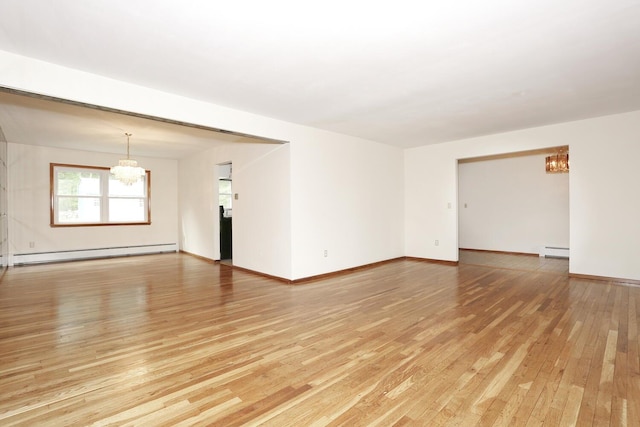 19 Verona Ct, New City, NY 10956 - unfurnished room featuring a chandelier, a baseboard heating unit, light wood-style flooring, and baseboards