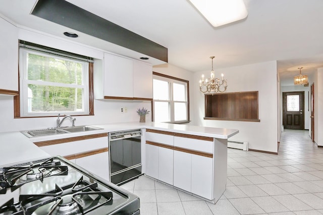 19 Verona Ct, New City, NY 10956 - kitchen with dishwasher, range with gas cooktop, a sink, a chandelier, and a peninsula