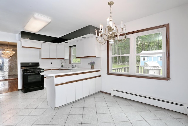 19 Verona Ct, New City, NY 10956 - kitchen with black gas stove, a chandelier, a baseboard heating unit, and a peninsula