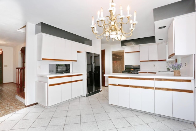 19 Verona Ct, New City, NY 10956 - kitchen featuring black microwave, freestanding refrigerator, range, a chandelier, and light countertops